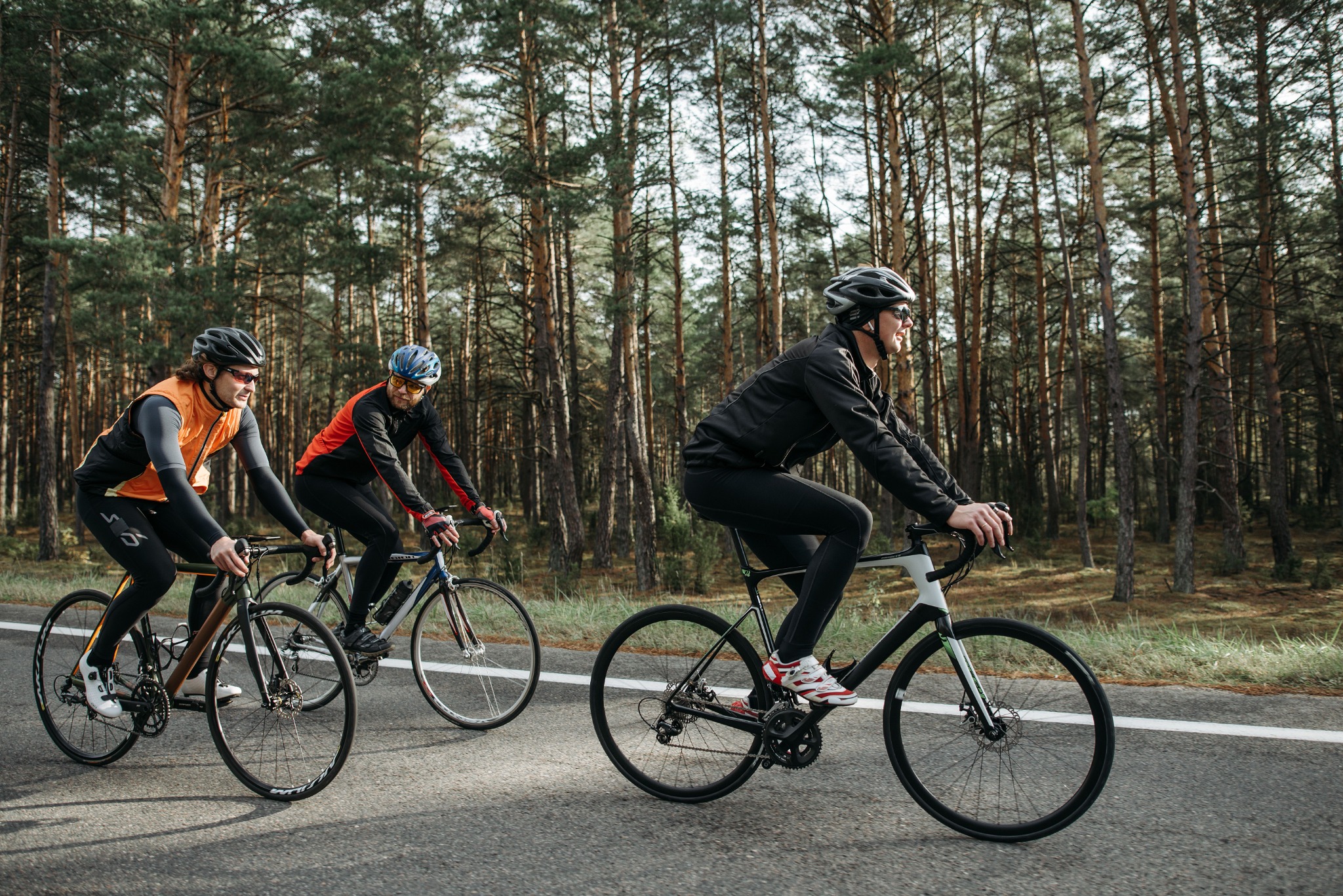 Three club riders on a quiet forest road