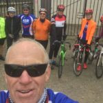 Group of club cyclists standing outside club house