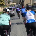 Backs of people riding on bikes